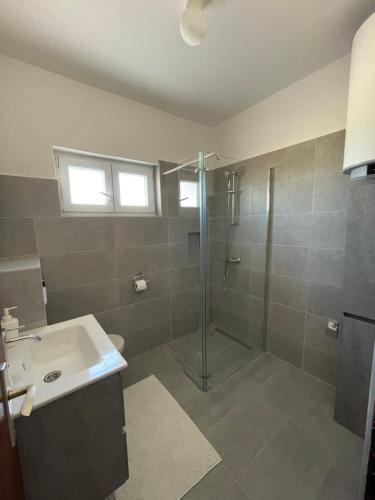 a bathroom with a shower and a sink at Apartmani Fulir in Vrsi