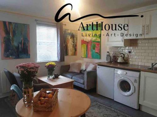 an apartment living room with a table and a kitchen at The Art House 1 Galway, Woodquay in Galway