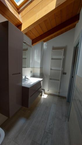 a bathroom with a sink and a wooden ceiling at B&B Santa Croce in Fanano