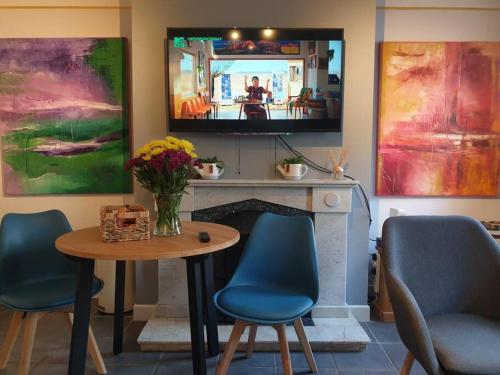 a living room with a table and chairs and a tv at The Art House 1 Galway, Woodquay in Galway