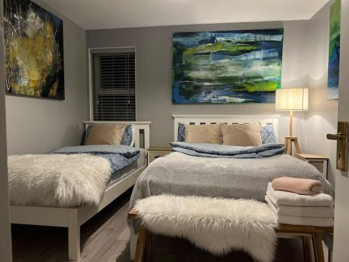 a bedroom with two beds and a painting on the wall at The Art House 1 Galway, Woodquay in Galway