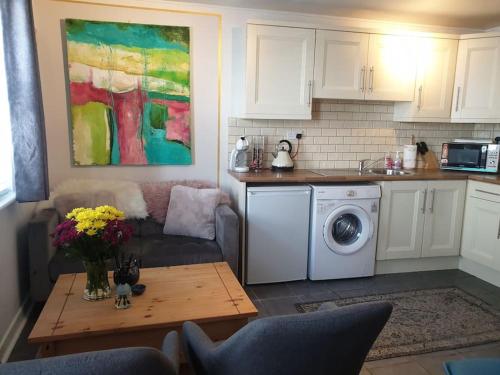 a kitchen with a couch and a table in a living room at The Art House 1 Galway, Woodquay in Galway