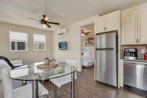 a kitchen and dining room with a table and a refrigerator at Beach Downtown Pet-friendly 1 BD @ The Park-633 in Sarasota