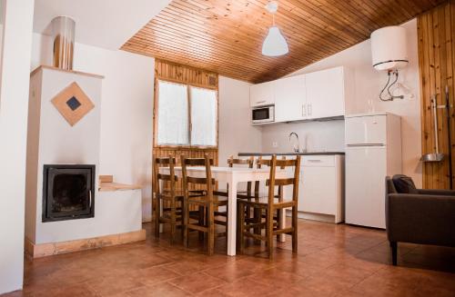 a kitchen and living room with a table and chairs at Gaztainuzketa Mendi Etxeak in Leintz-Gatzaga