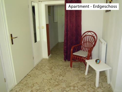 a chair and a table in a hallway at Ferienwohnung Wolfsholz in Wernigerode