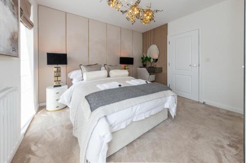 a bedroom with a large bed and a chandelier at Cozen in Stone Grove