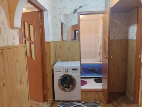 a laundry room with a washing machine in it at Karakol apartment in Karakol