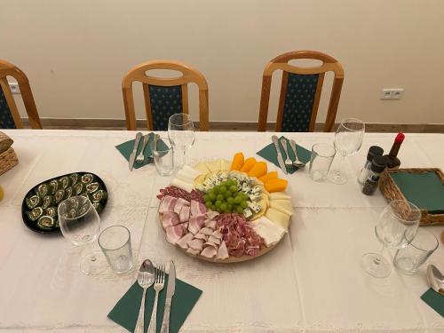 a table with a plate of food and wine glasses at Leśna Polana in Sękocin Stary