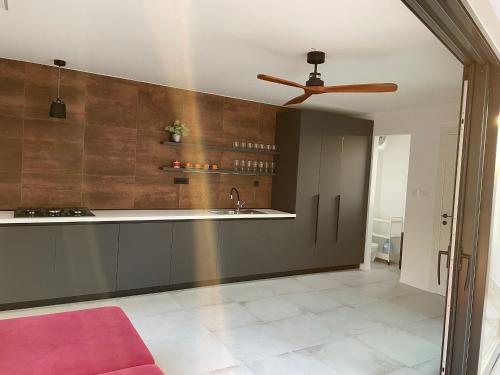 a kitchen with a sink and a ceiling fan at Villa LeANN in Okrug Donji