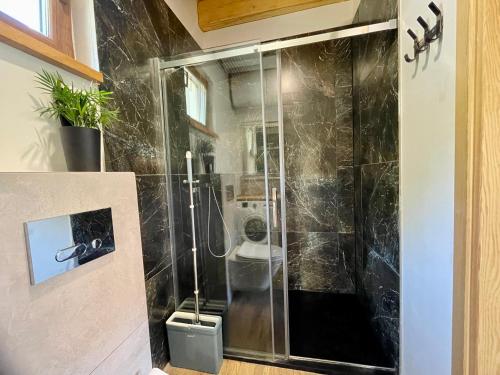 a shower with a glass door in a bathroom at Pieprz i WANILIA Kopalino domek z widokiem na las 3 pokoje parking taras WiFi - Wanilia in Kopalino