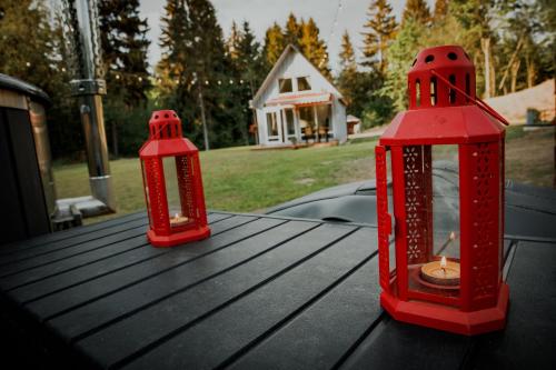 two red lanterns sitting on top of a table at Wolf Cottage in Pabaži