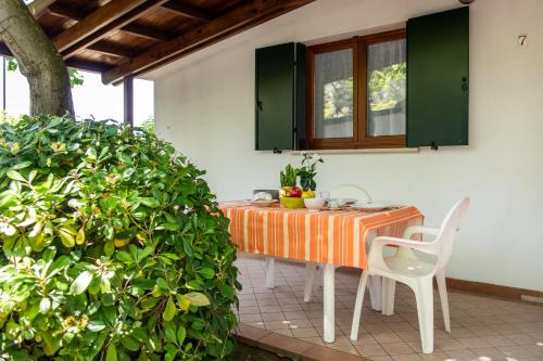 an orange table and chairs on a patio at La Conchiglia in Chioggia