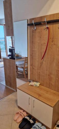 a room with a wooden wall with a red hose at Студио Тони 2 с панорамна тераса и морска гледка Варна in Varna City