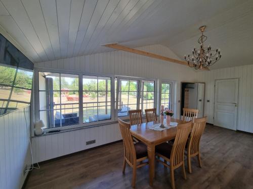 a dining room with a wooden table and chairs at Šventoji in Palanga