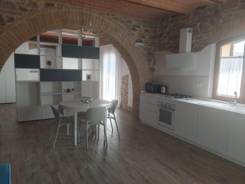 a kitchen with a table and chairs in a room at Podere Feltrino in Grosseto