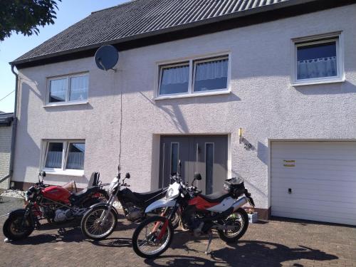 two motorcycles parked in front of a house at Casa Mona in Gonzerath