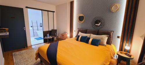 a bedroom with a large yellow bed and a bathroom at Casa Vigna in Anse
