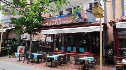 a group of tables and chairs in front of a restaurant at Agora Boutique Apart Hotel in Alanya