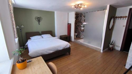 a bedroom with a bed and a table in it at Villa Stella Maris in Ostend