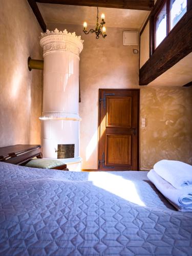 a bedroom with a large bed with a cake on it at Penzion Baroko in Český Krumlov