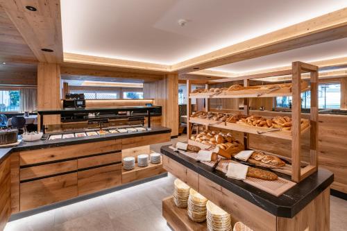 a bakery with lots of different types of bread at Hotel Alpina in Ried im Zillertal