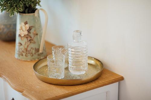 a tray with glasses and a bottle on a table at Château Saint-Pierre de Mejans in Puyvert