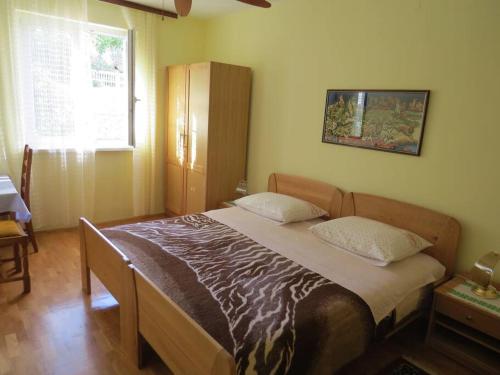 a bedroom with a large bed in a room at Apartment with 2 terrace in Cres