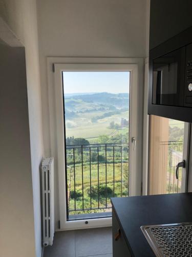 a kitchen with a large window with a view at La casa di Isola in Peccioli