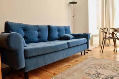 a blue couch sitting in a living room at Żeromskiego Residence in Słupsk