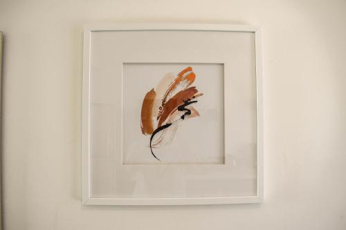 a framed picture of a feather on a wall at Hotel Venedik in Veracruz