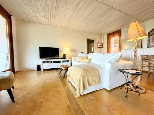a bedroom with a large white bed and a flat screen tv at Quinta Do Marvao in Marvão