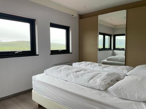a bedroom with two beds and a large mirror at Modern villa - in Golden Circle - Gullfoss Geysir Þingvöllur - Freyjustíg 13, 805 Selfoss in Búrfell