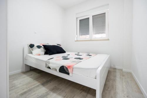 Postel nebo postele na pokoji v ubytování Apartmani Neuense