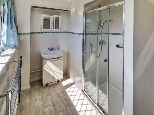 a bathroom with a shower and a sink at Solent View in Seaview