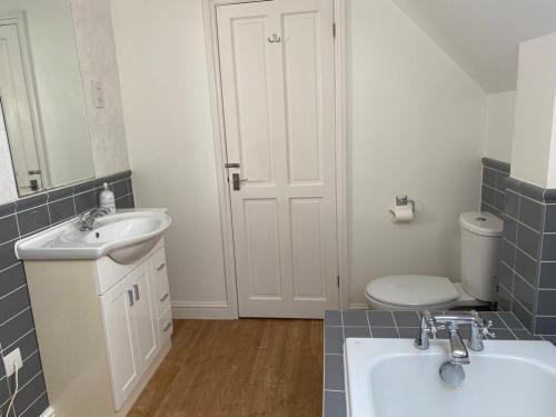 a bathroom with a sink and a toilet at The Retreat 