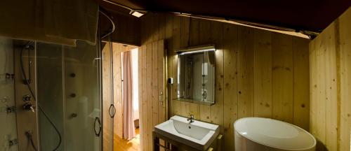 a bathroom with a sink and a toilet and a mirror at Drago Tours LODGE TENT Holiday Deluxe, Lanterna in Poreč