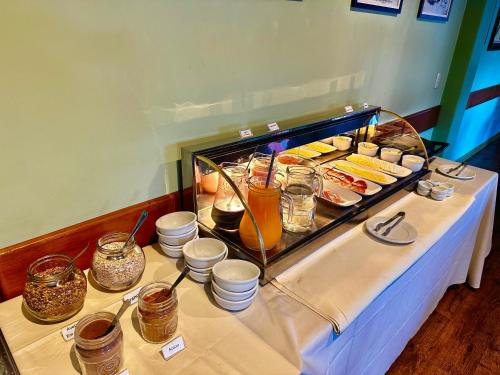 a buffet table with food and drinks on it at Natur Hotel - 700m da Rua Coberta in Gramado