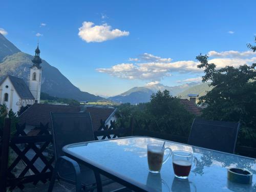 una mesa en un balcón con vistas a las montañas en Apartment Ana, en Arzl im Pitztal