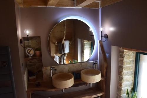 a bathroom with two sinks and a mirror at Domaine Moulin de Quincenat Gîte Moulin au Bois Dormant in Champagnat