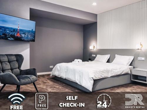 a bedroom with a bed and a chair and a tv at DAVID'S RENTAL ROOMs in Bucharest