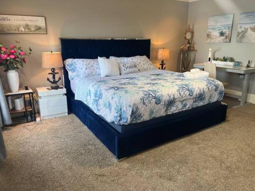 a bedroom with a large blue bed in a room at Luxurious Chalet over Margaritaville in Buford