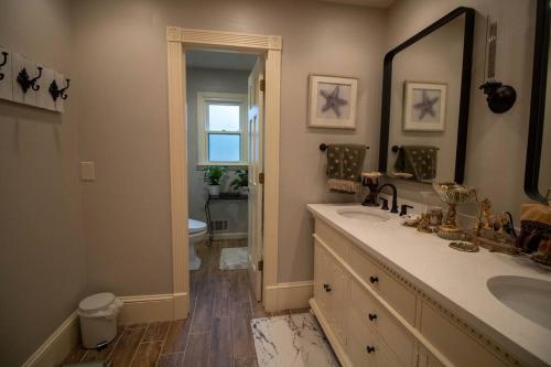 a bathroom with two sinks and a mirror at Luxurious Chalet over Margaritaville in Buford