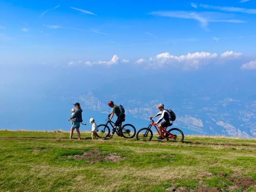 a group of people riding bikes on a hill at Natur Resort Panorama in Malcesine