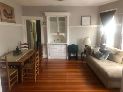 a living room with a couch and a table at Pleasant 2br apartment in Cambridge in Cambridge