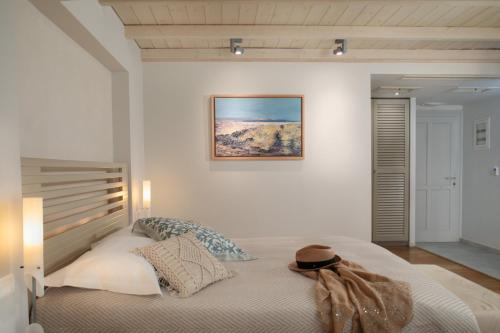 a bedroom with a bed with a picture on the wall at Iria Beach Art Hotel in Agia Anna Naxos