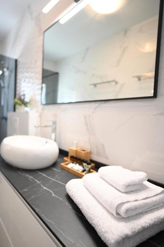 a bathroom with a sink and towels on a counter at Apartment Mina Dream in Jelsa