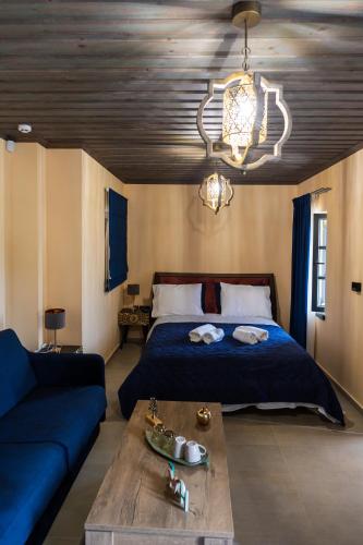 a bedroom with a bed and a blue couch at The five keys in Monodendri