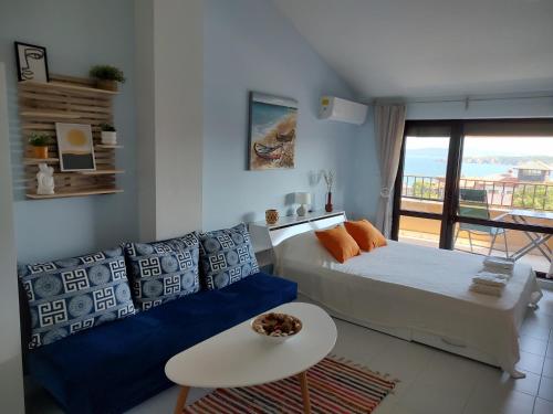 a living room with a bed and a couch at Studio Senso di Mare in Sozopol