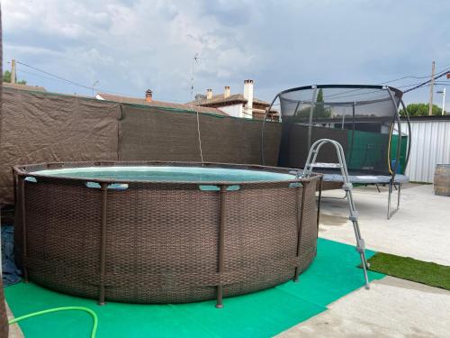 a patio with a trampoline and a table and a glass at Casa Abuela Nila in Cogeces de Iscar