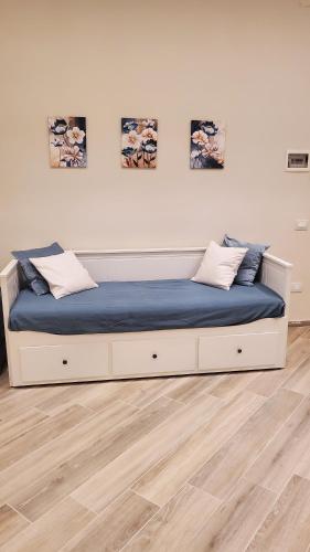 a bed with blue sheets and pillows in a room at Domus Mia in Tivoli
